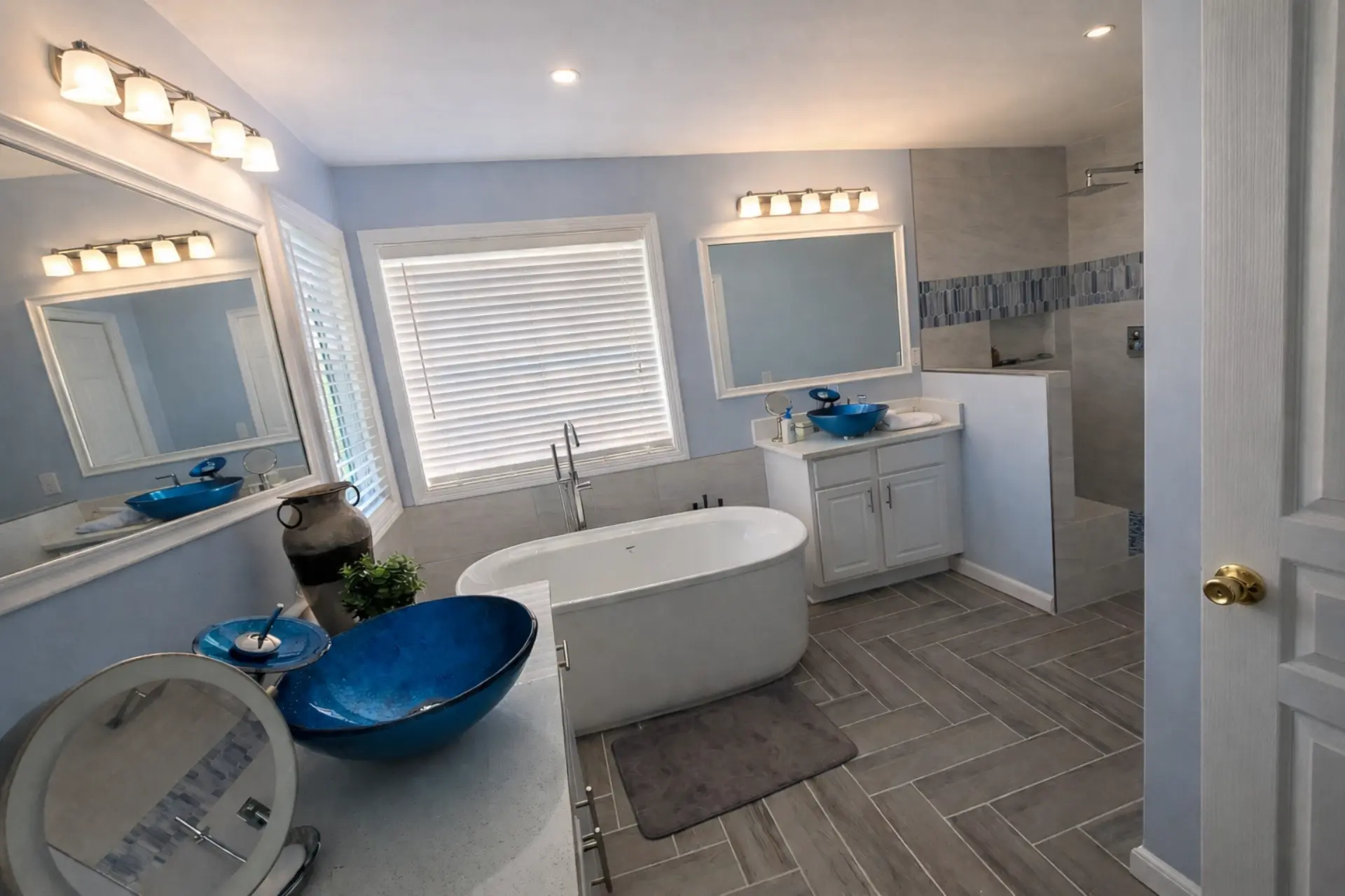 Dunwoody bathroom with a freestanding tub and herringbone tile