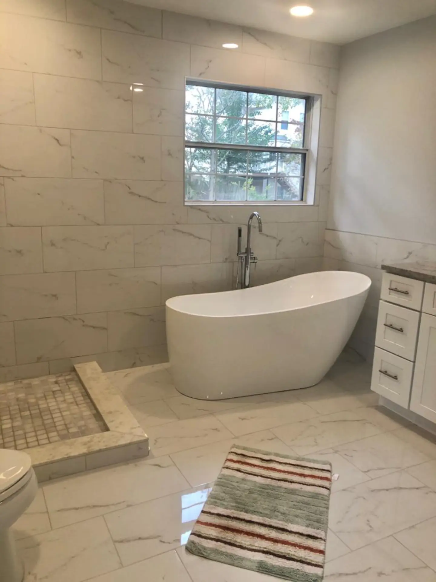 Suwanee luxury marble tile bathroom freestanding tub